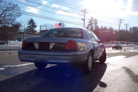 2001 Ford Crown Victoria - A blue Ford Crown Victoria is parked on the side of the road with snow on the ground.