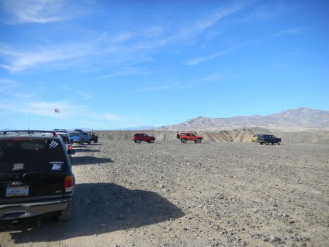 1997 Ford Ranger - Several off-road vehicles are parked in a desert area under a bright blue sky.