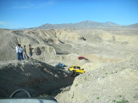 1997 Ford Ranger - Several off-road vehicles navigate a challenging desert terrain under a clear blue sky.
