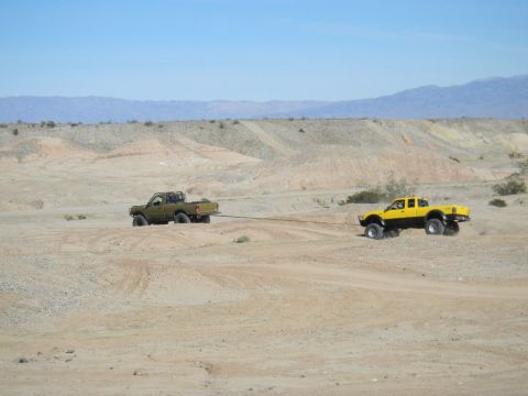 1997 Ford Ranger - Two trucks are being used for off-roading in a desert environment, with one towing the other.