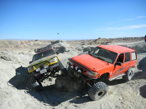 1997 Ford Ranger - These two trucks are tackling a challenging off-road course with steep inclines and rocky obstacles.