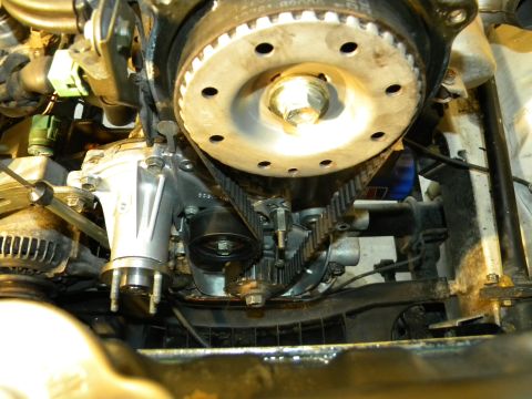 1988 Ford Bronco - Close-up view of an engine's timing belt and water pump system.