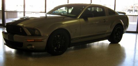 2000 Mercury Grand Marquis - Silver coupe with black racing stripes and side stripe, likely a Ford Mustang Shelby GT500.