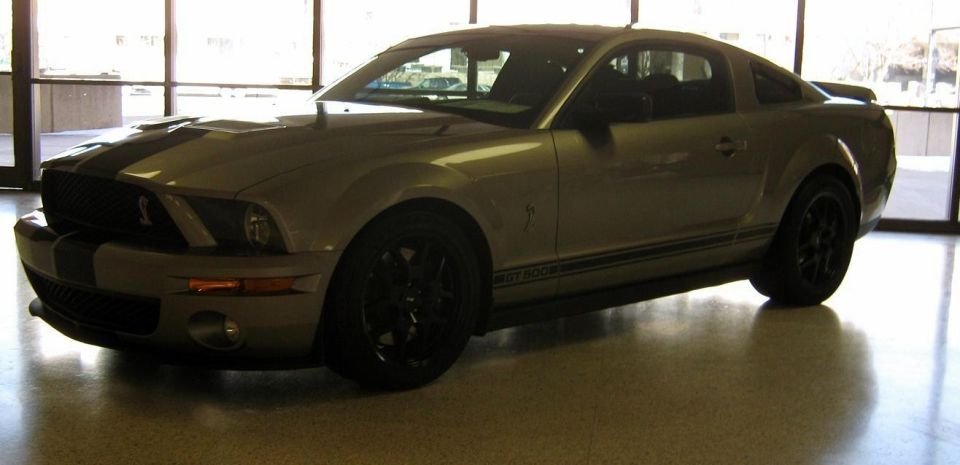 Silver coupe with black racing stripes and side stripe