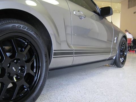 2000 Mercury Grand Marquis - Side profile of a gray 2007 Ford Mustang Shelby GT500 with SVT wheels and racing stripes.