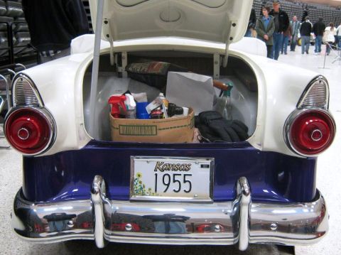 2000 Mercury Grand Marquis - This classic car, identified by its 1955 license plate, is displayed with its trunk open, revealing cleaning supplies and a pair of gloves.