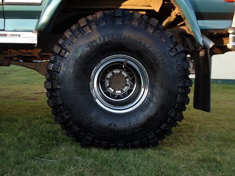 1996 Ford Bronco - A large off-road tire with 'SUPER SWAMPER' text is visible on the side of a vehicle.