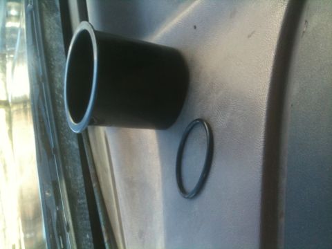 1993 Ford Bronco - Close-up of a vehicle's interior door panel showing a cup holder and an o-ring.