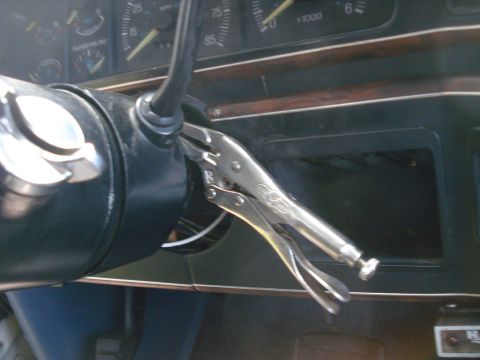 1989 Ford F-250 - Vice grips are clamped onto the steering column of this vehicle's interior, obscuring the ignition.