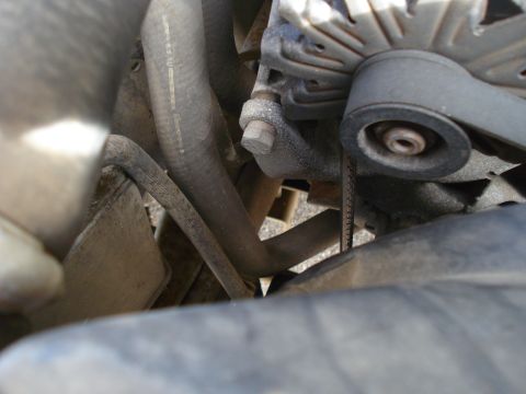 1989 Ford F-250 - Close-up view of the engine compartment of a 1989 Ford F-250, showing various mechanical parts.