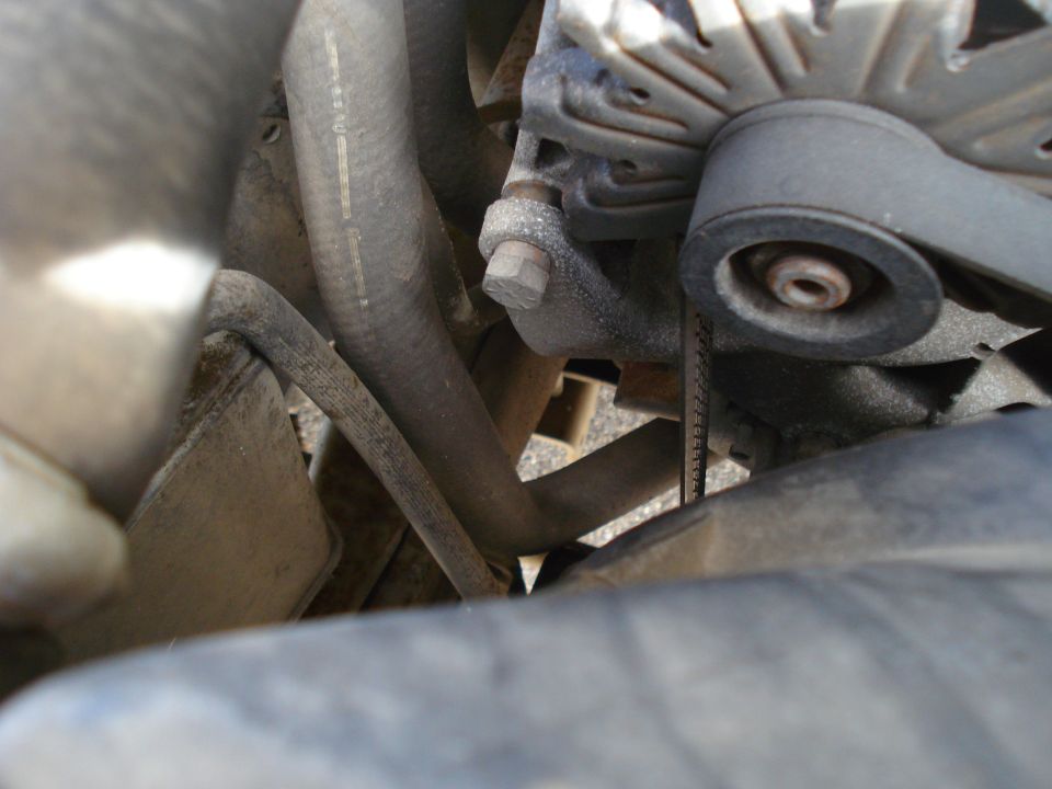 1989 Ford F-250 engine bay with alternator, hoses, and belt visible