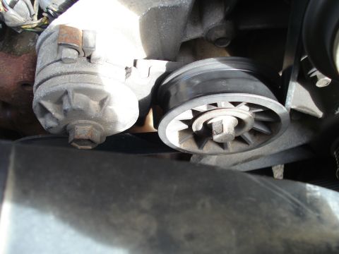 1989 Ford F-250 - Close-up view of an engine belt tensioner pulley and related components.