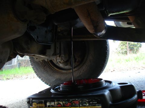 1989 Ford F-250 - Oil draining from the oil pan of a 1989 Ford F-250 during an oil change.