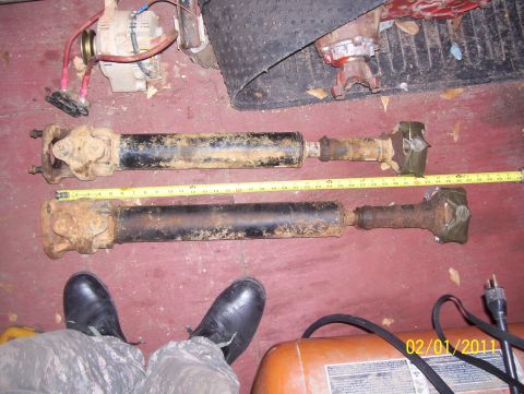 1978 Ford Bronco - Two driveshafts are laid out and measured, with an alternator and other equipment in the background.