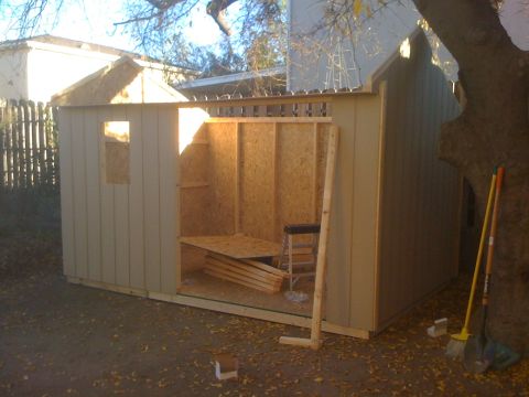 1968 Ford Mustang - A shed is being built, with its interior framing and unfinished walls visible.