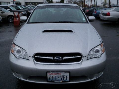 2006 Subaru Legacy - A silver Subaru Legacy is parked outside a dealership, with other cars visible in the background.