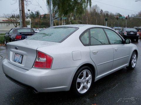 2006 Subaru Legacy - Silver 2006 Subaru Legacy sedan parked on a wet street, showing its rear 3/4 profile.