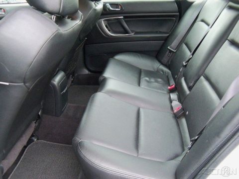 2006 Subaru Legacy - Rear interior view of a car, showing the black leather seats and door panel.