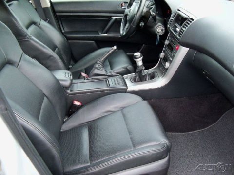 2006 Subaru Legacy - The interior of a car is shown, black leather seats and a manual transmission shifter.