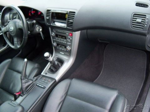 2006 Subaru Legacy - Interior view of a car's dashboard, center console, and seats, showing a manual shifter and audio system.