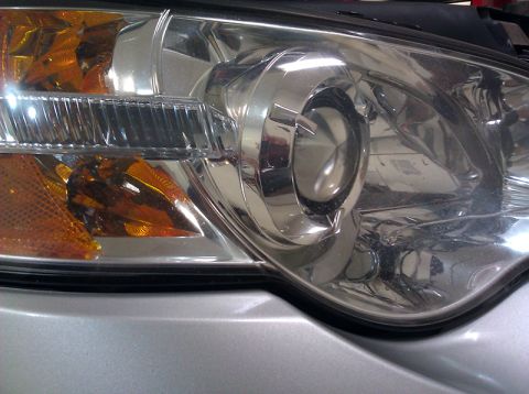 2006 Subaru Legacy - Detail of a car's headlight, focusing on the turn signal and chrome accents.