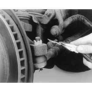 1992 Ford Bronco - Remove the cotter pin from the castellated nut at the ball stud
