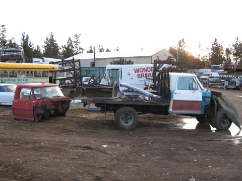 1972 Ford F-250 - Junkyard scene with a 1972 Ford F-250 flatbed and a red truck cab, plus a school bus.