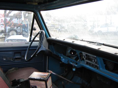 1972 Ford F-250 - The interior of a truck cab, with a tow truck visible through the windshield.