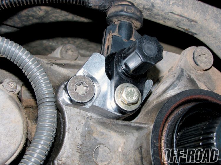 Wheel speed sensor bolted to axle knuckle with bracket, Torx bolt and wiring conduit