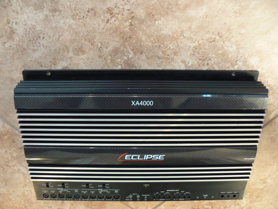 Black Eclipse XA4000 car amplifier with silver fins and carbon fiber accents