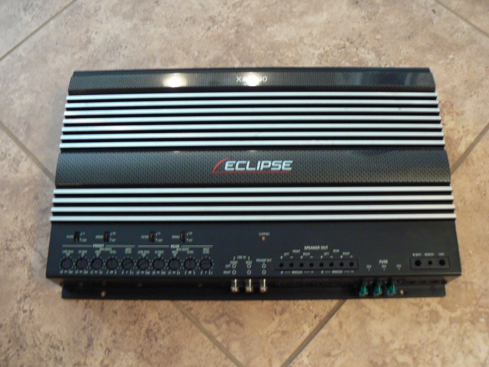 Black car amplifier with silver fins and 'ECLIPSE' logo, showing input and output terminals