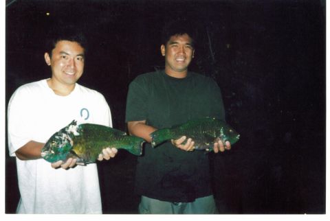 1991 Ford Bronco - Two men proudly display their catch of the day, holding up two large fish.