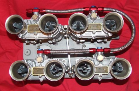 1973 Ford Mustang - A pair of dual Weber carburetors, likely for a performance engine, are displayed against a red cloth surface.
