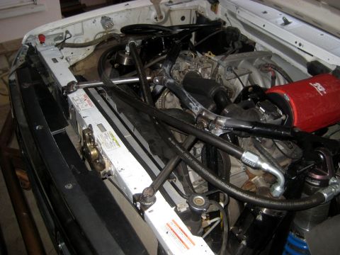1996 Ford Bronco - Engine bay view of a white 1996 Ford Bronco, a red K&N air filter and various hoses and components.