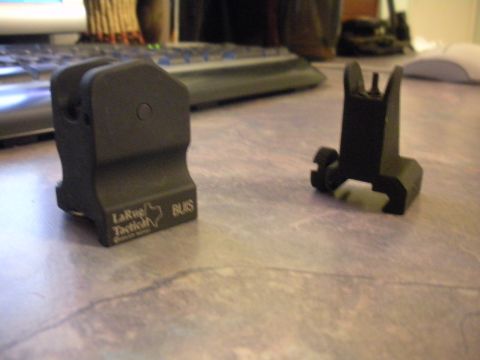 1996 Ford Bronco - Two tactical gun sights are displayed on a desk next to a keyboard.