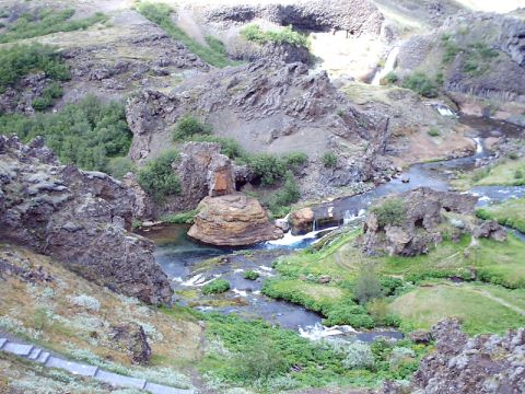 1996 Ford Bronco - A scenic view of a river flowing through a rocky, vegetated canyon with several small waterfalls.