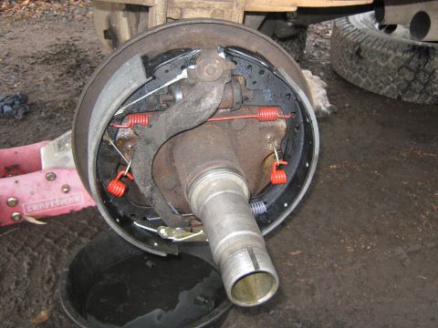 1972 Ford F-250 - Drum brake assembly with new parts, including red springs and brake shoes. A Craftsman jack is visible.