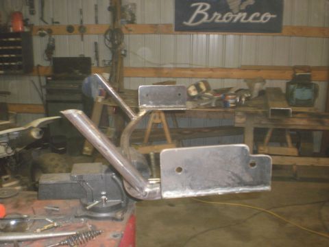1995 Ford Bronco - Custom fabricated metal part being worked on in a garage, with a "Bronco" sign visible on the wall.