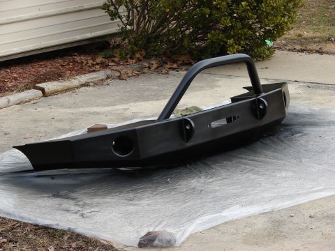 1995 Ford Bronco - A black aftermarket front bumper with a brush guard is shown, likely awaiting installation.