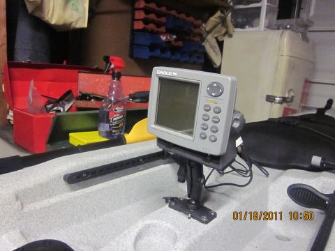 1953 Ford Mainline - A fish finder is mounted on a kayak, with various tools and supplies visible in the background.