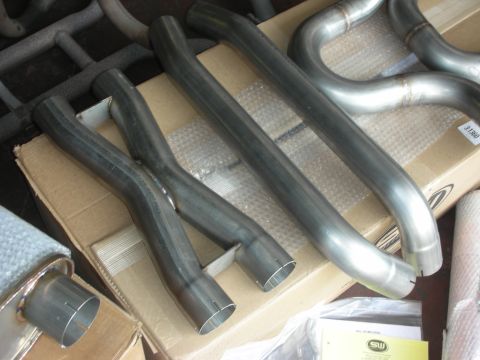 2004 Ford Crown Victoria - Close-up of custom exhaust system components, including an X-pipe and bent tubing.