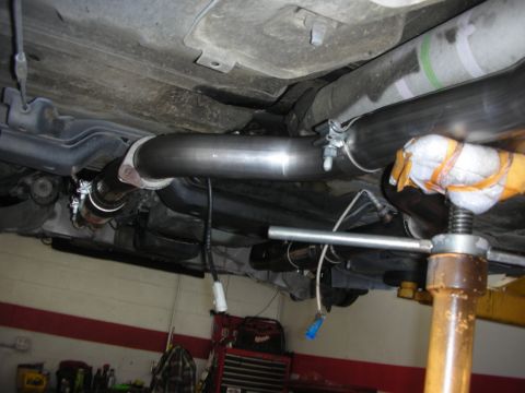 2004 Ford Crown Victoria - Custom exhaust system installation visible from underneath a vehicle.