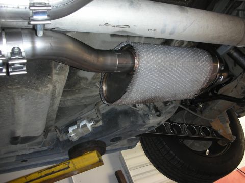2004 Ford Crown Victoria - Underside view of a custom stainless steel exhaust system, a heat-wrapped muffler and visible piping.