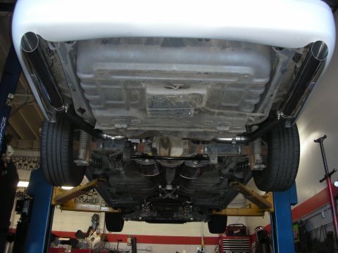 2004 Ford Crown Victoria - Custom dual exhaust system with chrome tips visible from underneath the vehicle.