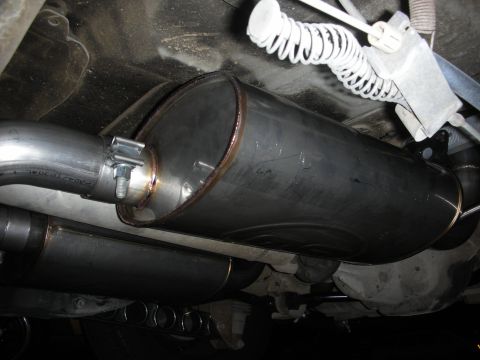 2004 Ford Crown Victoria - Aftermarket exhaust system components are visible underneath a vehicle.