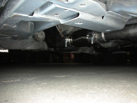 2004 Ford Crown Victoria - Custom exhaust system installed on a vehicle, a prominent muffler and stainless steel piping.