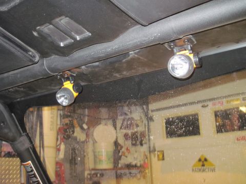 2005 Ford Excursion - Two auxiliary lights are mounted inside the UTV's cabin, illuminating the garage beyond.