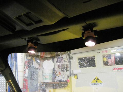 2005 Ford Excursion - Interior view of a vehicle's headliner with two lights, looking out at a garage door.