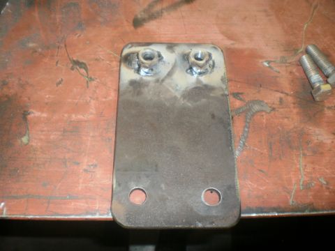 1995 Ford Bronco - A fabricated steel mounting plate with two hex nuts welded to its back side to serve as captive threads, plus two open bolt holes at the lo…