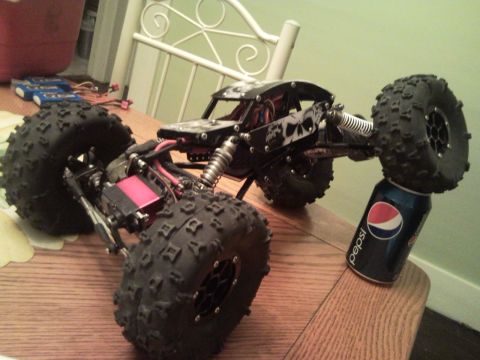 1989 Ford Bronco - This remote control rock crawler features skull graphics and a large tire resting on a Pepsi can.